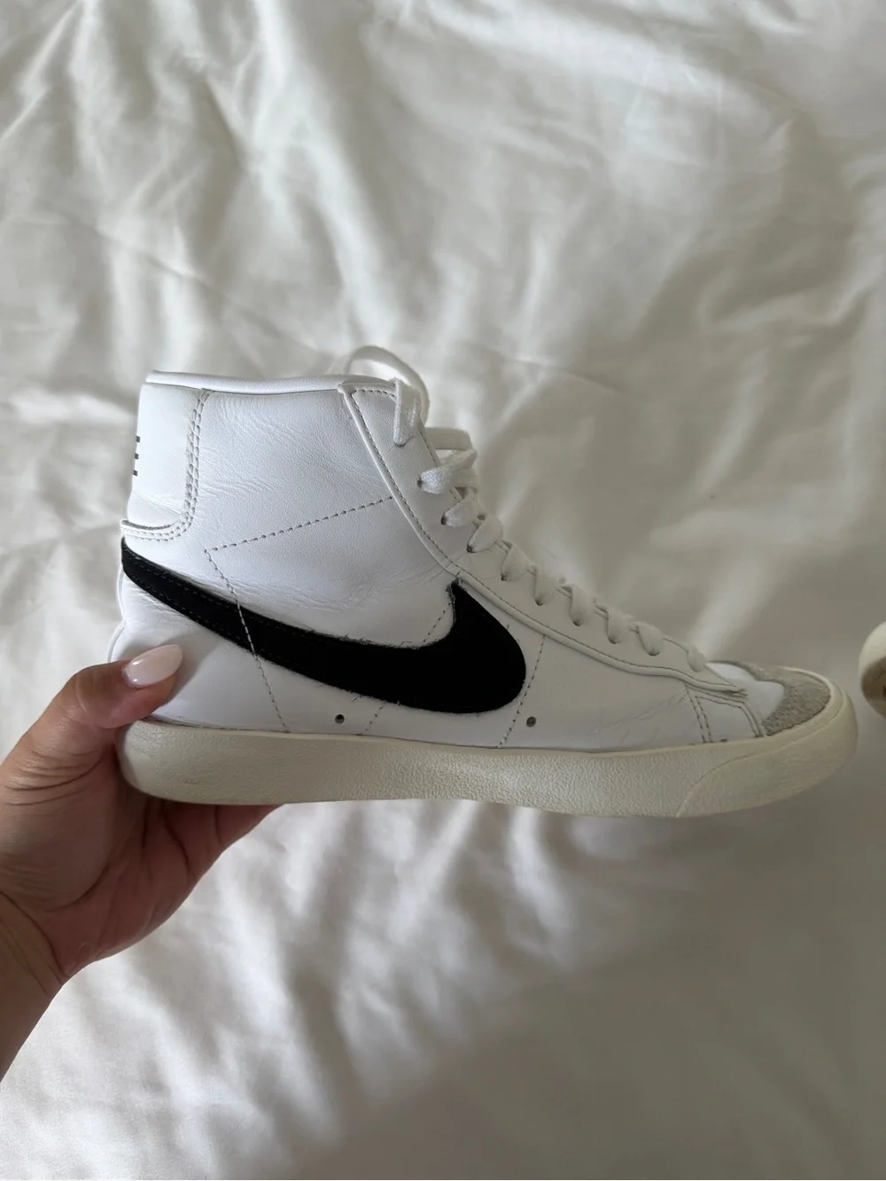 Nike White High-Top Sneakers with Black Swoosh and Orange Accent